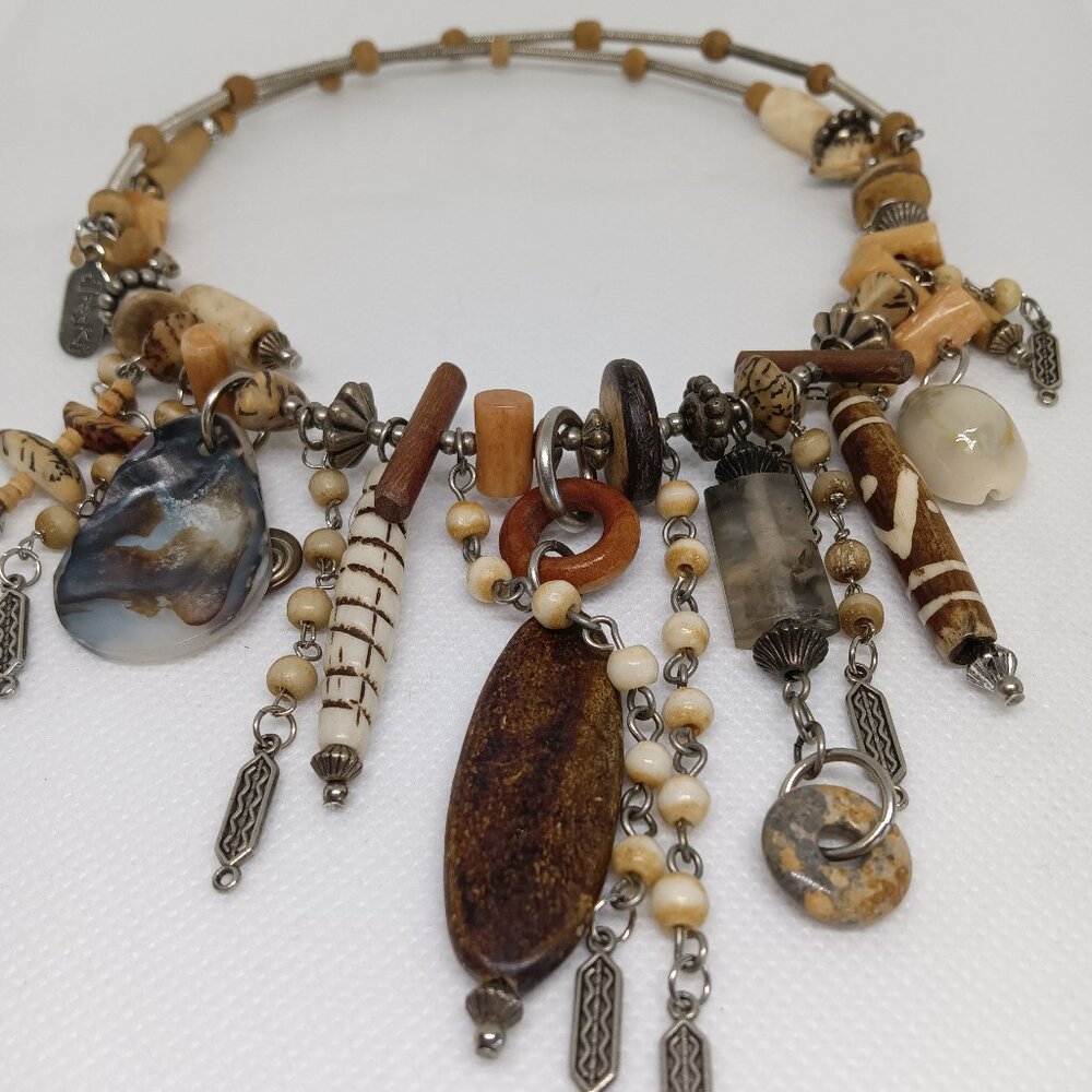 A preowned vintage Treska necklace in a mix of ceramic beads, shells and wood.